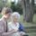 Life insurance claims - a young woman with an older woman sitting on a park bench.
